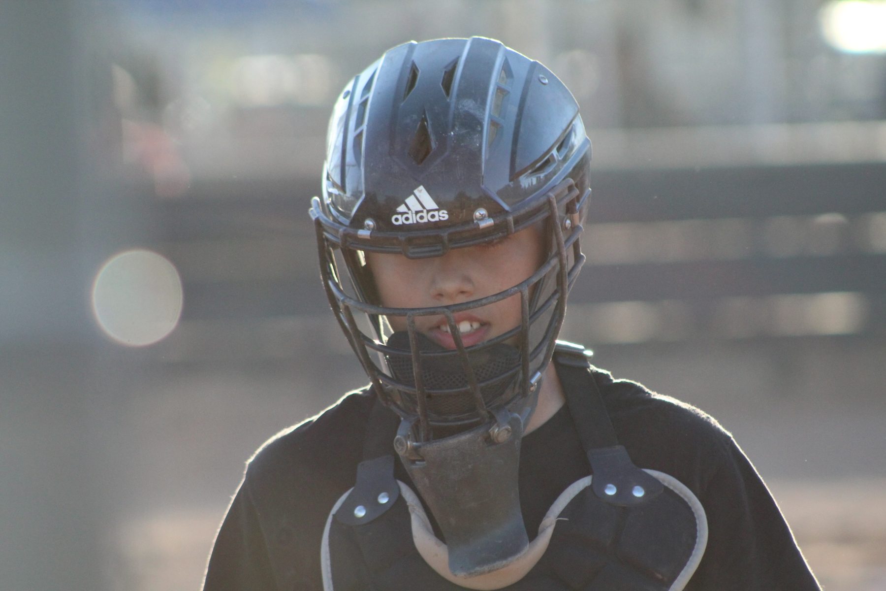 Close-up of Luke Sevilla in catcher gear