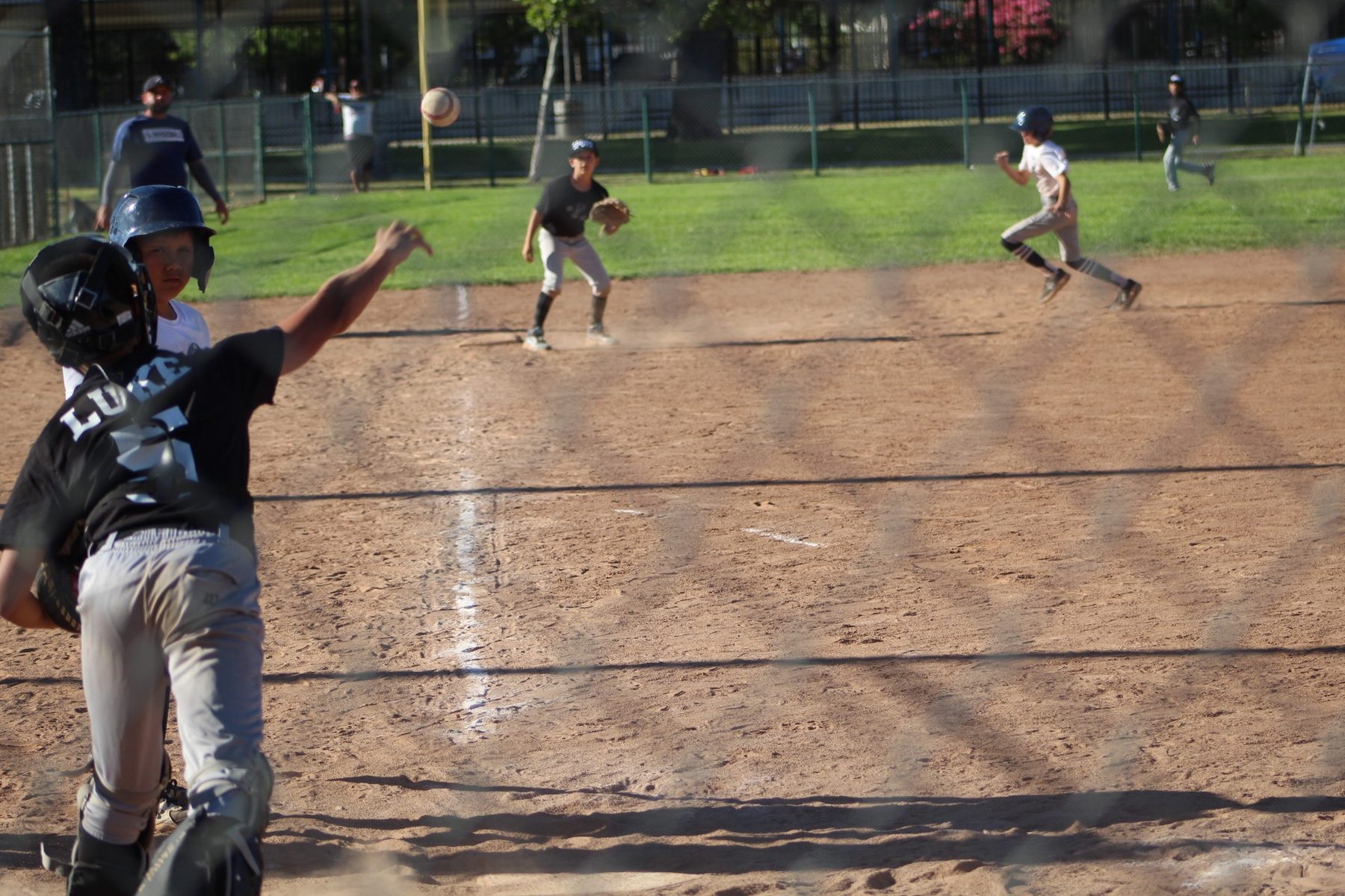 Luke Sevilla throwing from behind the plate