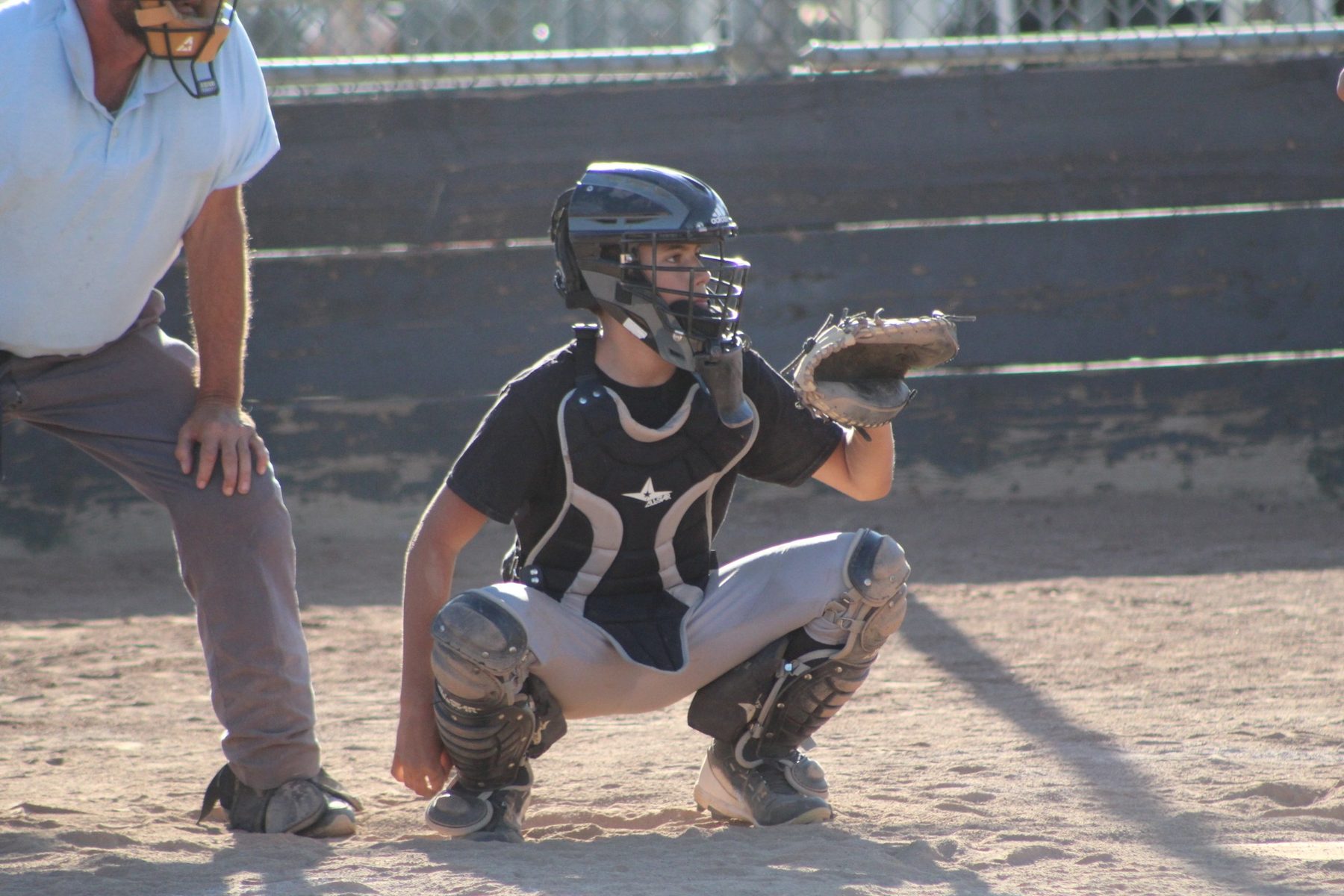 Young Luke Sevilla catching in travel baseball