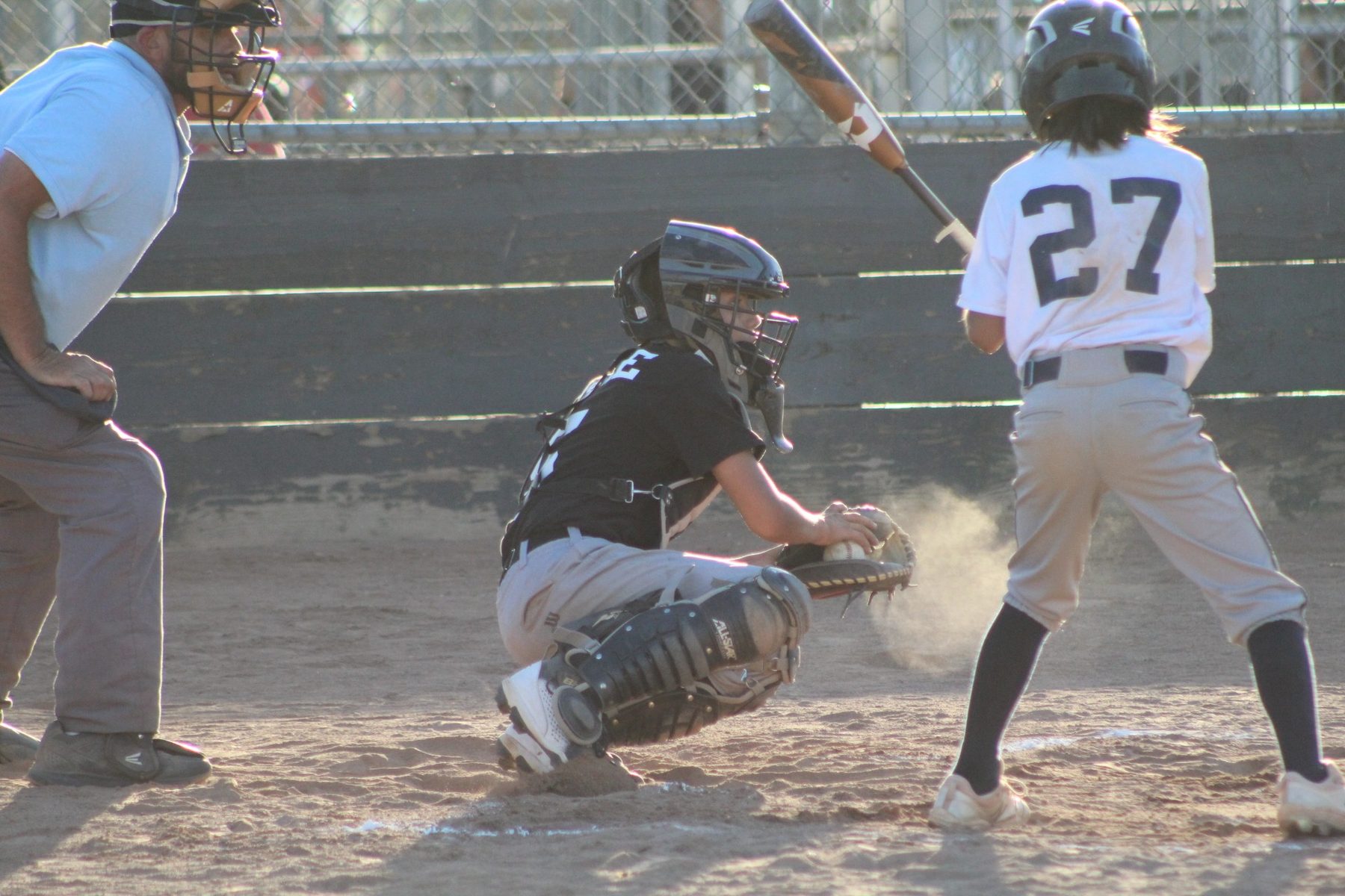 Luke Sevilla receiving a pitch at catcher