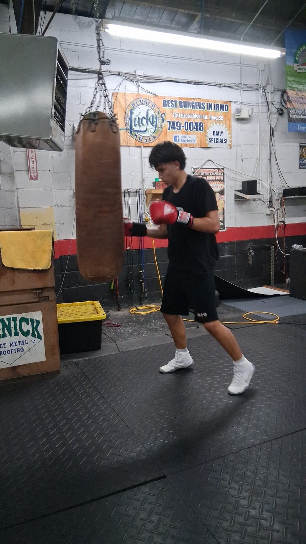 Luke Sevilla working the heavy bag during current boxing training