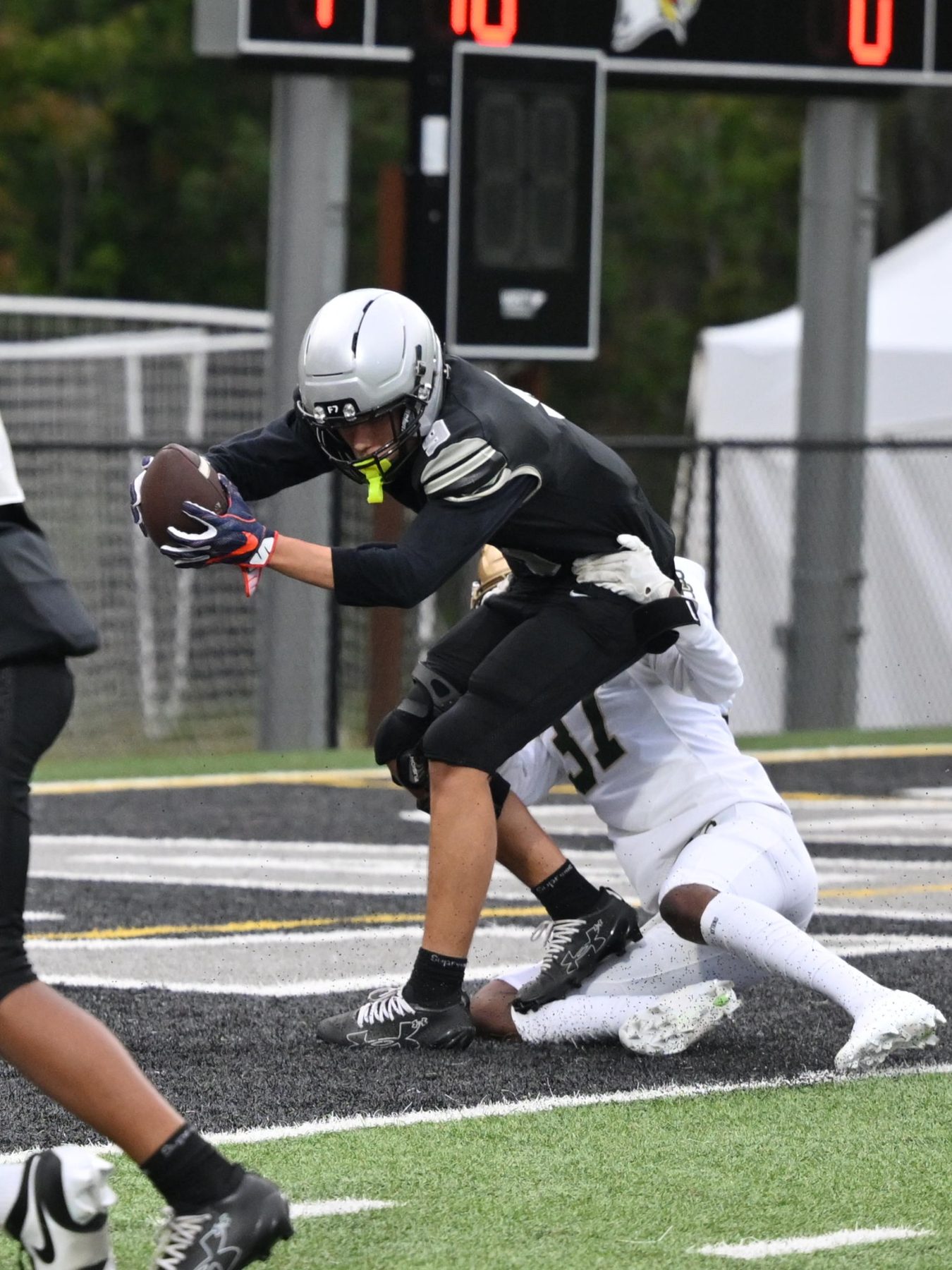 Luke Sevilla securing the football through contact for Gray Collegiate Academy