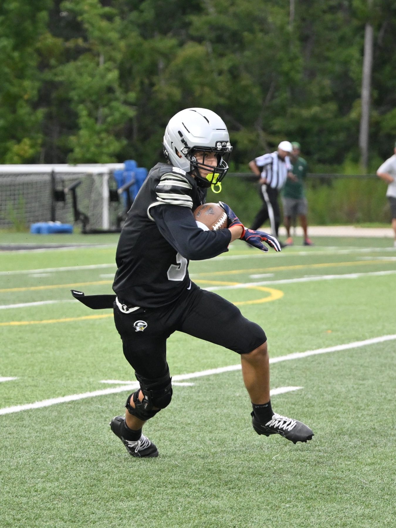 Luke Sevilla running in the open field for Gray Collegiate Academy