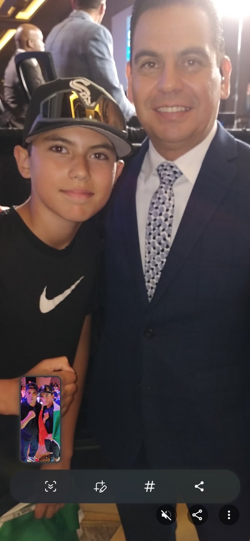 Young Luke Sevilla at a boxing event with a championship belt nearby