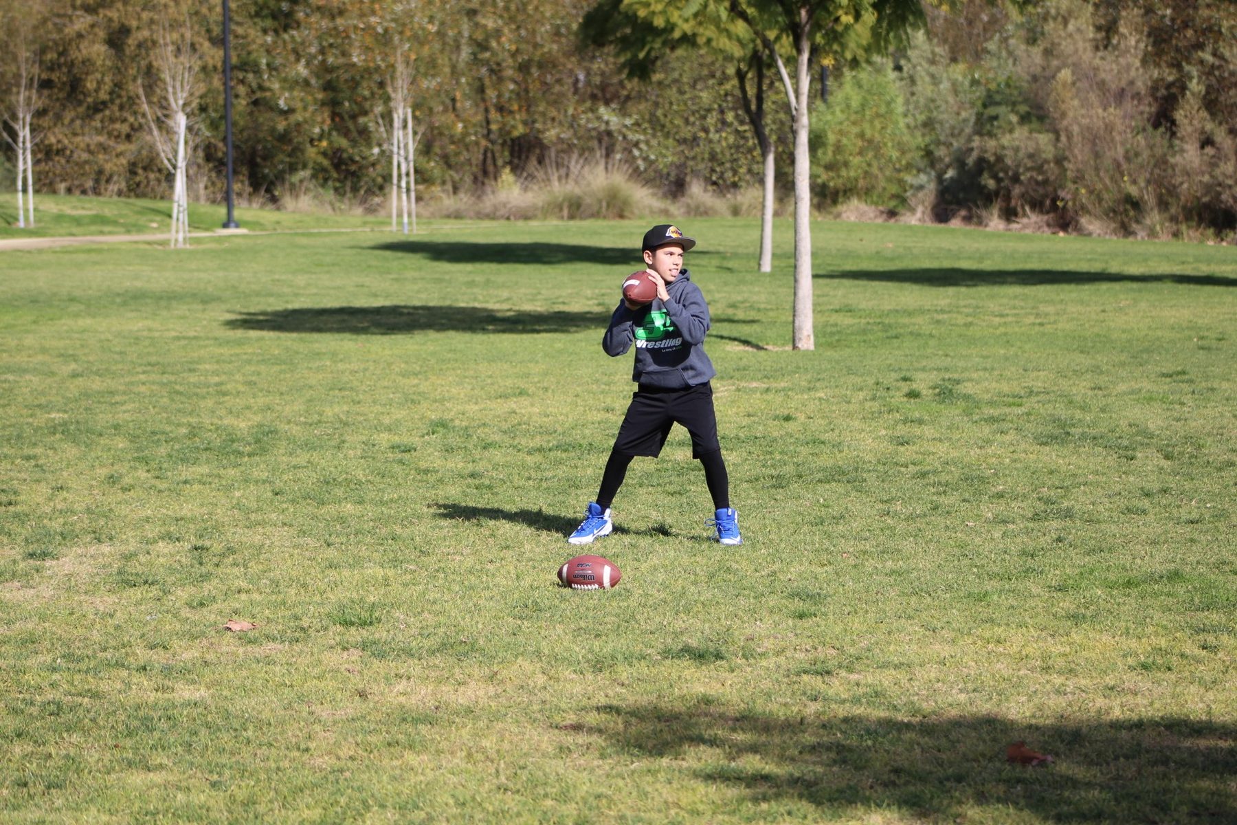 Luke Sevilla setting to throw during youth football training