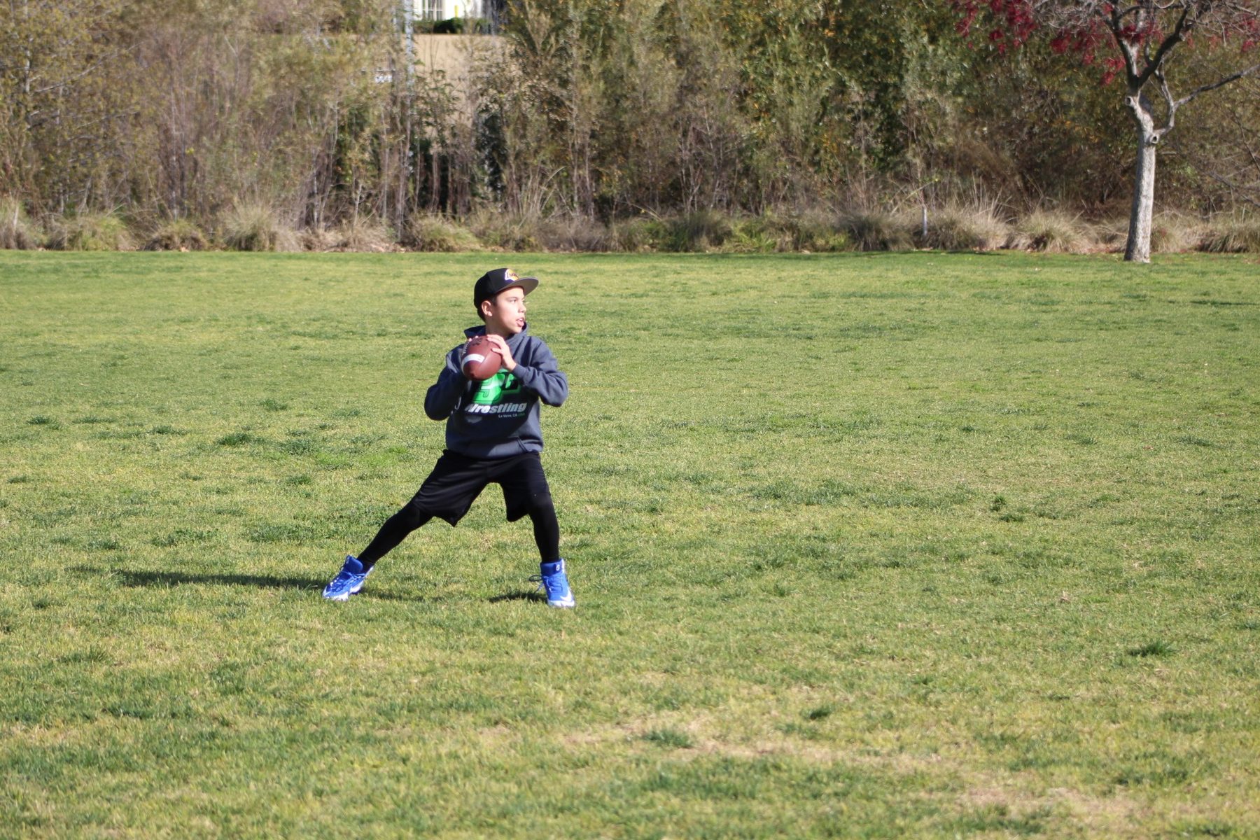 Luke Sevilla preparing to throw during youth football practice