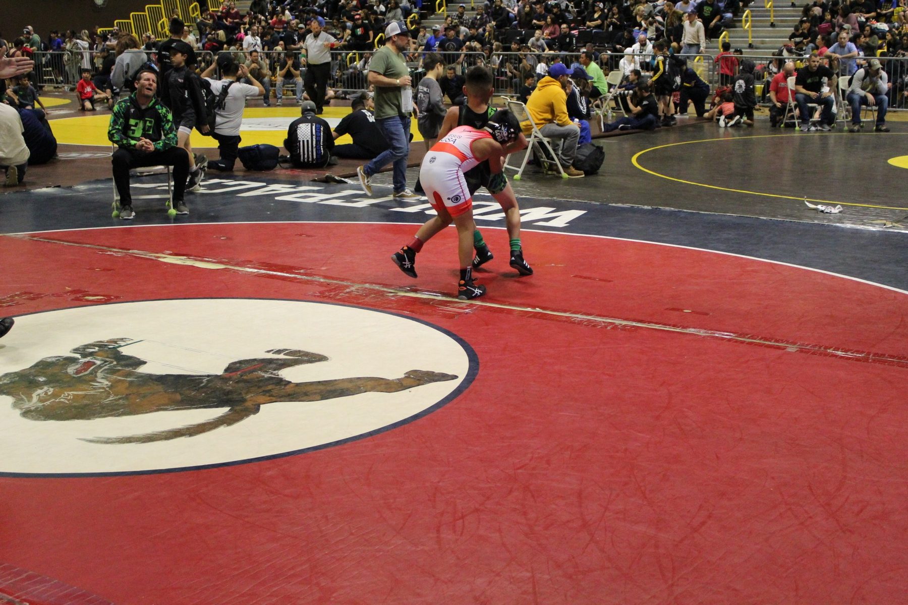 Luke Sevilla competing on a red wrestling mat