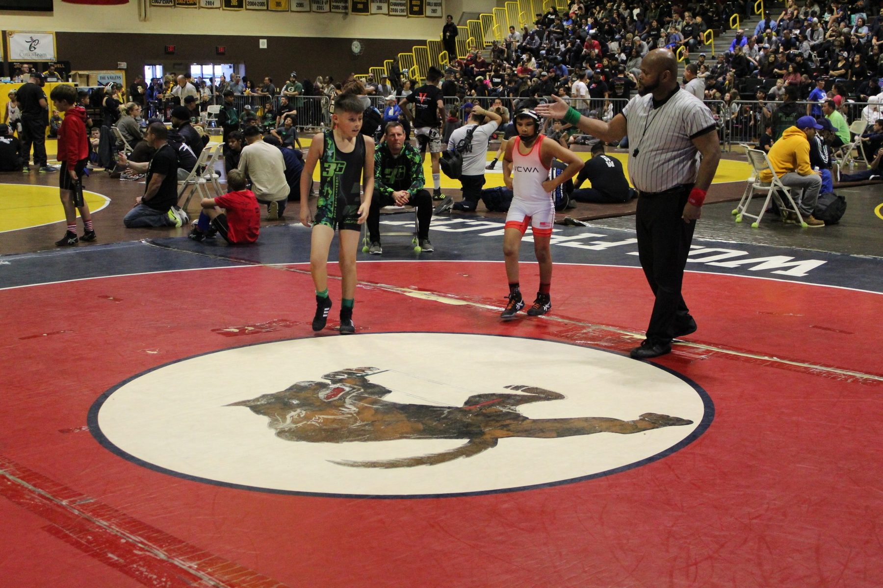 Luke Sevilla and an opponent during a youth wrestling bout